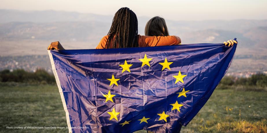 Image of two people holding an EU flag