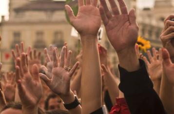 Raised hands in support for the ECI