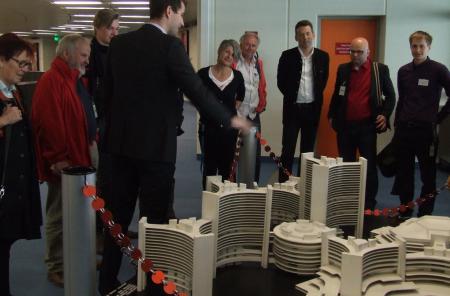 Participants of the guided tour look at a miniature of UN City in Vienna